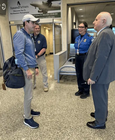 Rep. Bresnahan speaks with AVP officials and TSA agents.